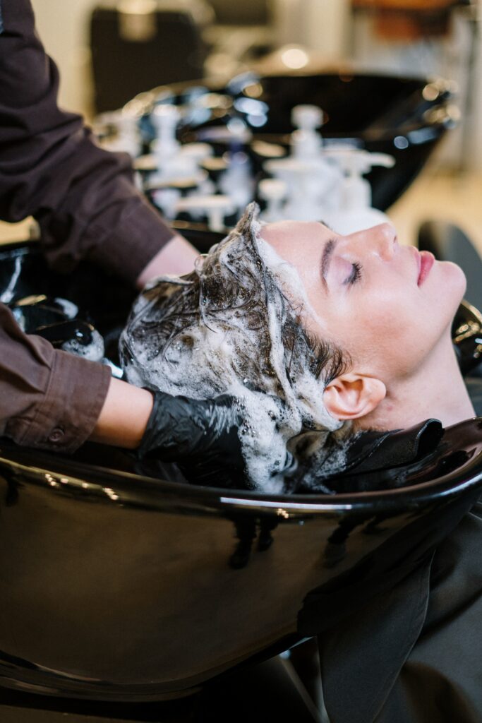 Lady getting hair washed at salon